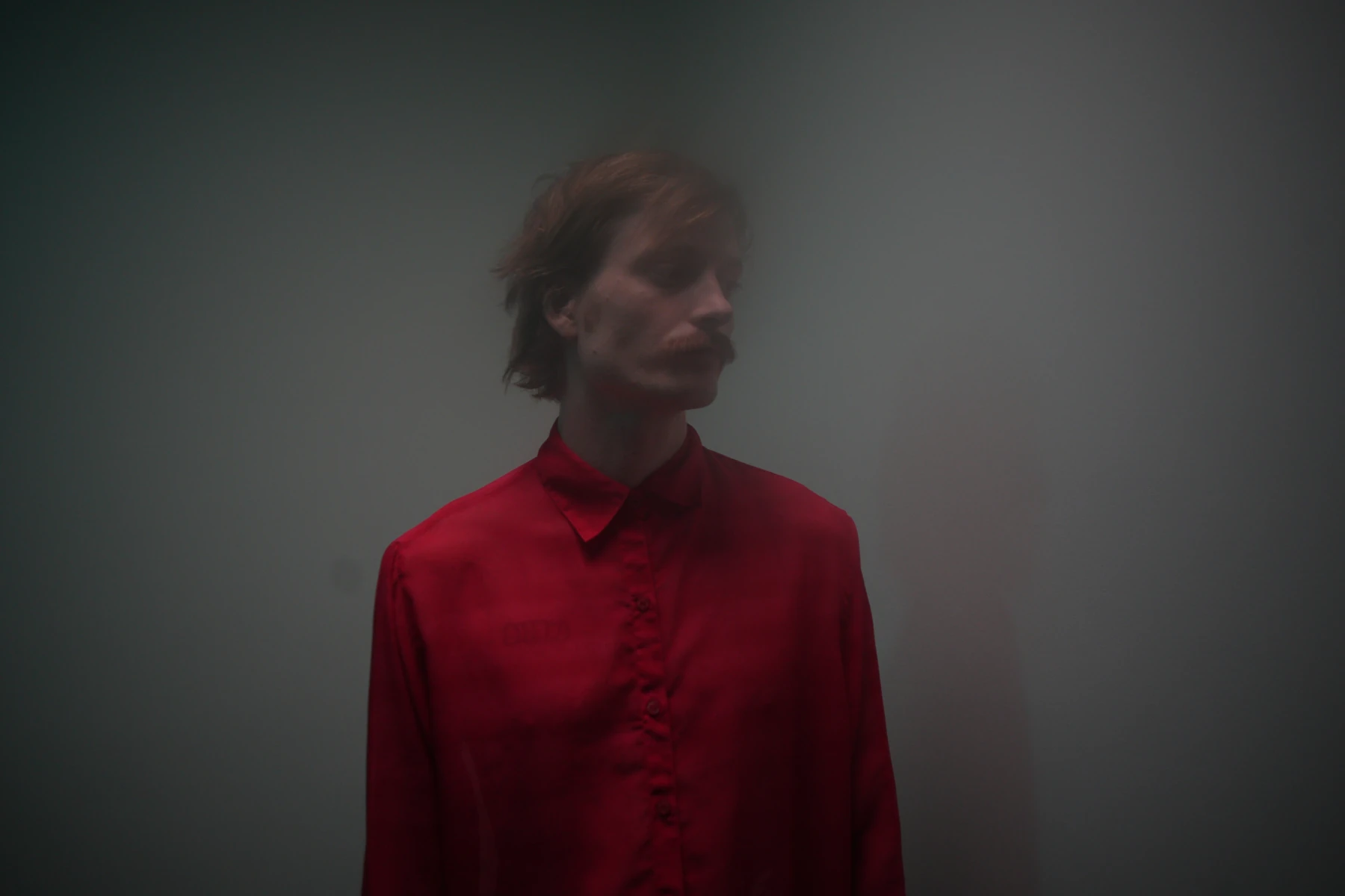 Portrait of Abraham Tilbury wearing a red shirt.